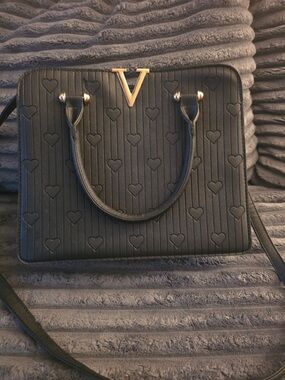 Structured Black Satchel with Heart-Embossed Detail and Gold V Accent